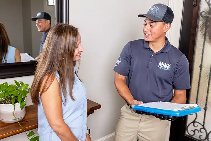 The Mink Plumbing tech helping customer