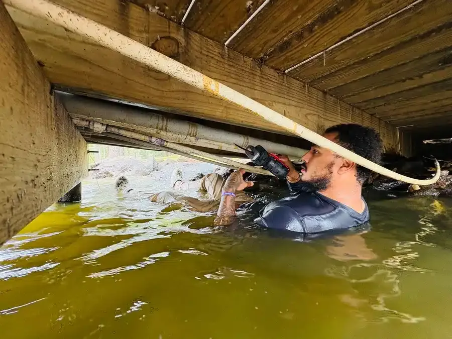 plumbing technician fixing flooded foundation
