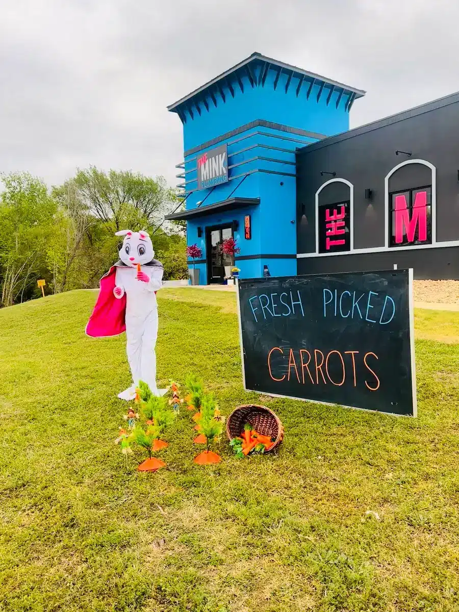 Eater bunny eating carrots outside of The Mink Plumbing