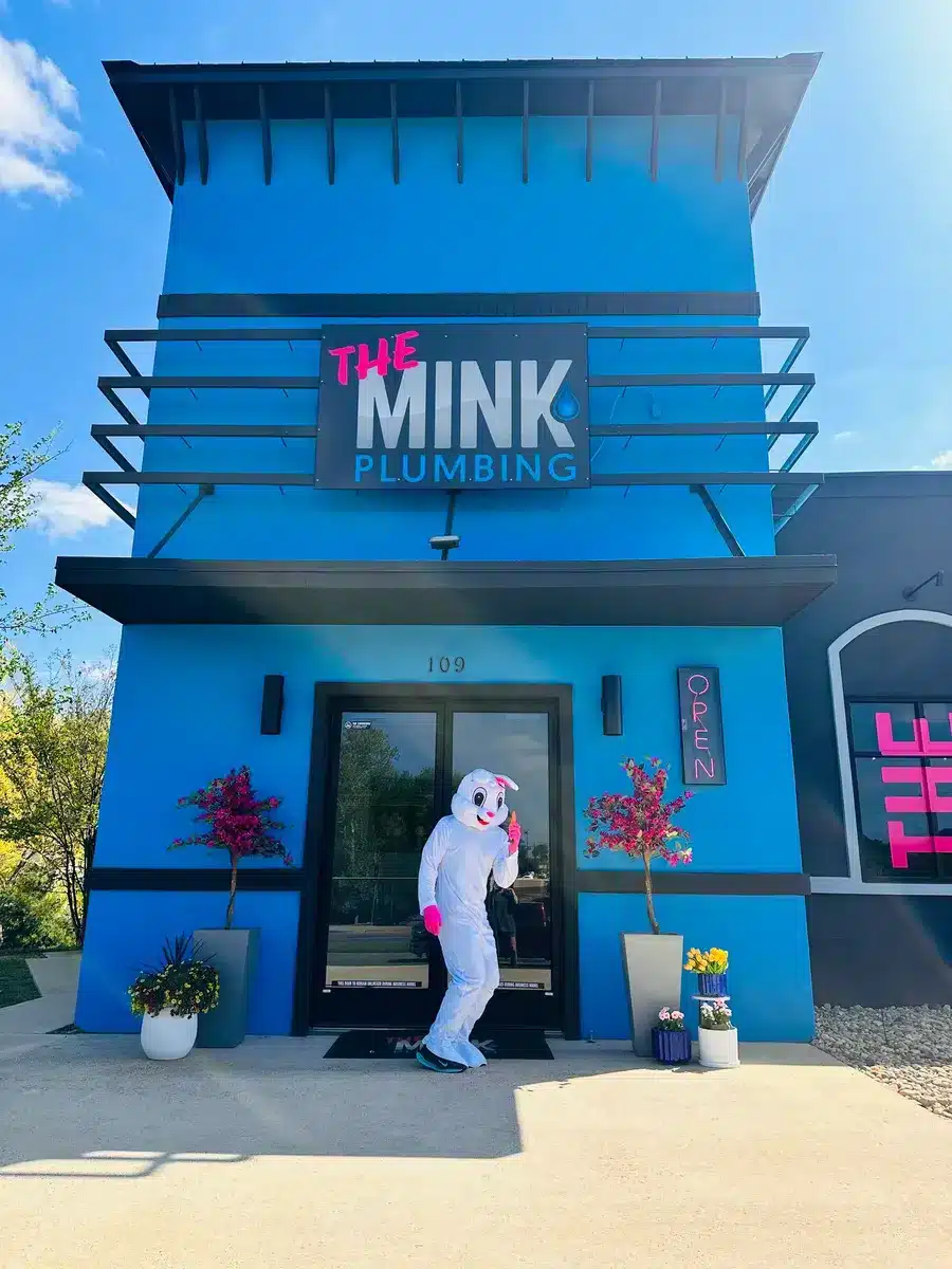 Easter bunny eating a carrot outside of The MInk Plumbing